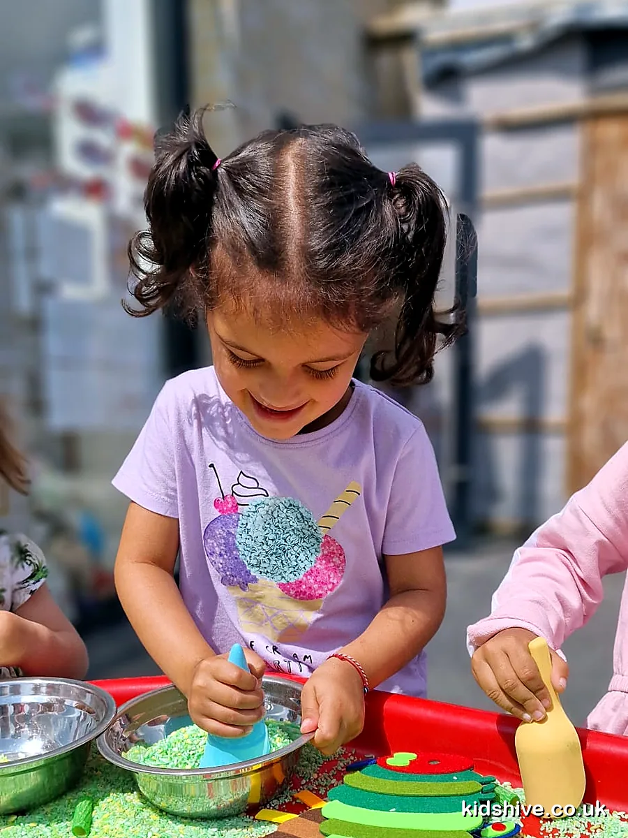 Messy sensory play with rice and scoops